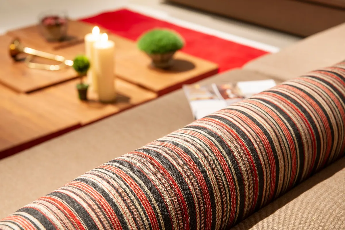 A close-up of upholstered fabric on a sofa in soft natural daylight