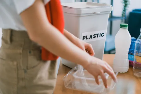 Disposable clear plastic takeaway food container on a light kitchen surface