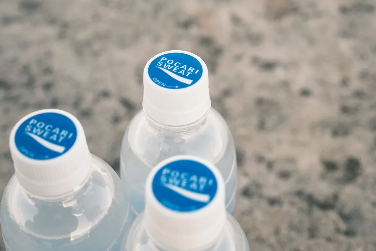 Clear plastic water bottles arranged on a light surface in natural daylight