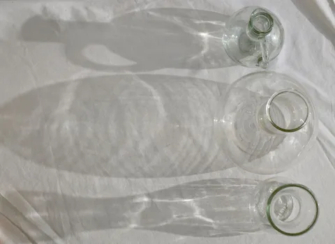 Clear glass of drinking water on a light surface in natural daylight