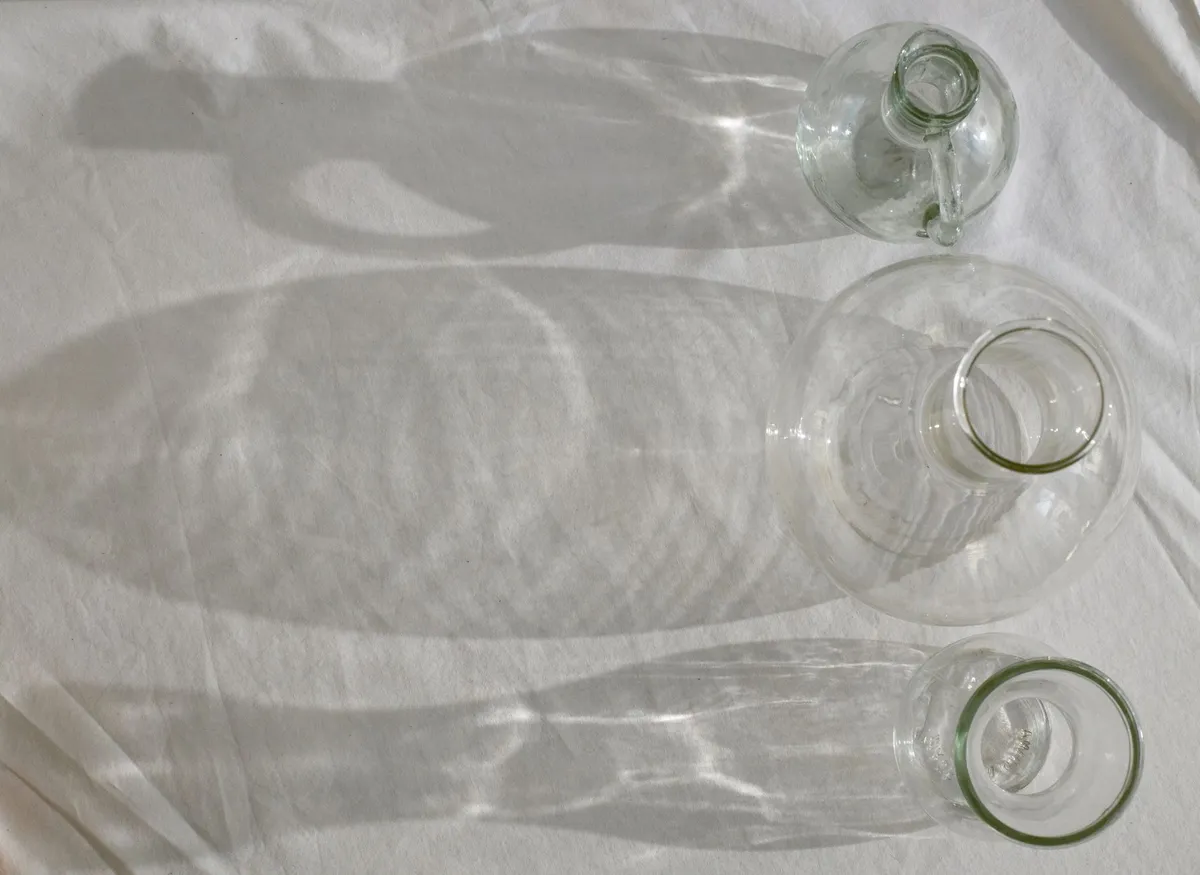 Clear glass of drinking water on a light surface in natural daylight